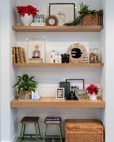 some shelves with pictures and plants on them