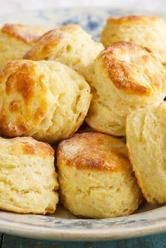 a plate full of biscuits sitting on top of a table