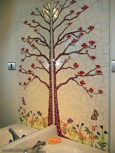 a bathroom with a tree on the wall