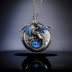 This stoic dragon has taken an oath to guard your most precious memories within this highly-detailed fantasy dragon locket necklace. The wings are hand-painted with a color shift effect that changes from blue to red-violet. There is a 11mm synthetic glass blue opal which nestles within its tail. The inside of the locket is large enough to fit herbs, medication, small notes, pictures and more! Choose from a silver, bronze or gunmetal toned chain up to 30" in length. I also have oxidized sterling Fantasy Pendant Art, Druid Necklace, Dragon Locket, Notes Pictures, Fantasy Pendant, Fantasy Necklace, Bronze Dragon, Small Notes, Necklace Locket