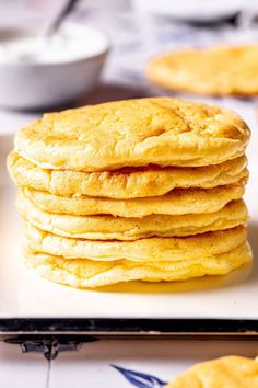 a stack of pancakes sitting on top of a white plate