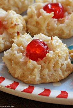 some cookies with jelly on them are sitting on a plate