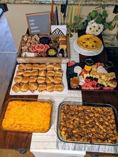 a table filled with lots of food and desserts on top of it's sides