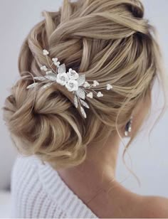 a woman wearing a hair comb with flowers on it