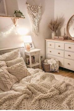 a bedroom with a bed, dresser and mirror on the wall next to each other