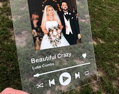 a person holding up a sign with an image of a bride and groom