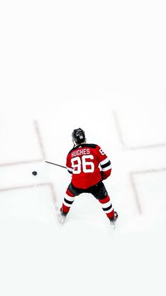 a man in red jersey playing hockey on snow covered ground