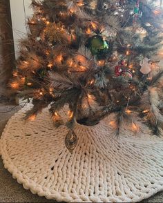 a crocheted christmas tree skirt on the floor