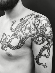 a man with an octopus tattoo on his arm and chest is looking at the camera