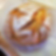 blurry image of donut on white surface with orange and yellow swirling around it