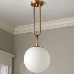 a light fixture hanging from the ceiling in a room with gray walls and white trim