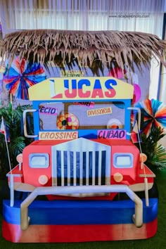 an ice cream truck is parked in front of a tiki hut on the grass