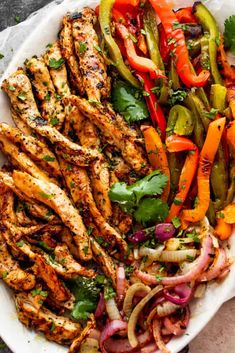 chicken fajita with peppers and onions on a white plate