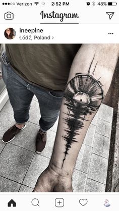 a person with a tattoo on their leg that has an image of a windmill in it