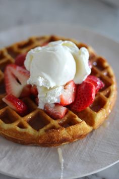 a waffle topped with ice cream and strawberries