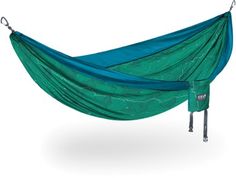 a green hammock hanging from a metal pole