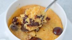 a spoon in a bowl filled with pudding and chocolate chips