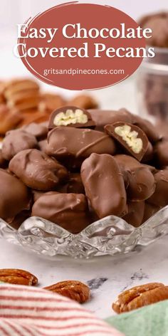 chocolate covered pecans in a glass bowl on top of a table with candy canes