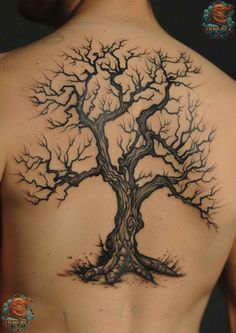 a man's back with a tree tattoo on his upper and lower half body