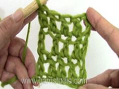 two hands are crocheting together to make a square