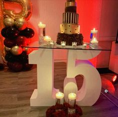 a table topped with candles and a cake