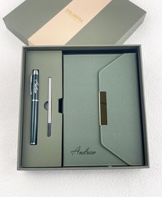 an open box with a pen and notebook inside