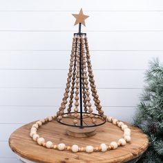 a wooden beaded christmas tree on top of a table