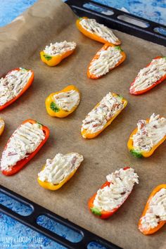 several mini stuffed peppers are on a baking sheet and ready to go into the oven