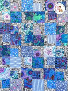 a blue and white patchwork quilt with flowers on the front, in different colors