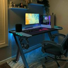 a desk with a computer and speakers on it