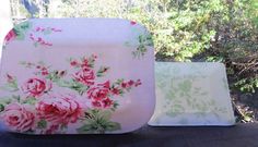 two plates sitting on top of a table covered in pink and green floral print fabric