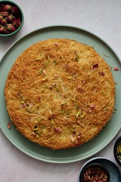 a cake on a plate with bowls of food around it