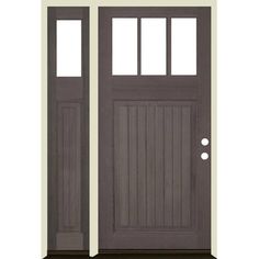 the front door is painted gray and has two sidelights on each side, with one light