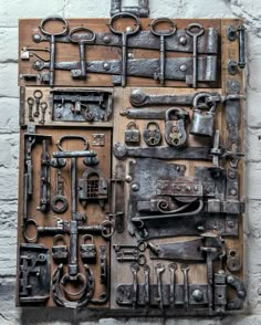 there are many different types of metal objects on this piece of art that is hanging on the wall