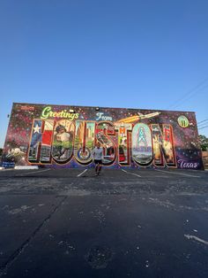 a person standing in front of a building with the word houston painted on it