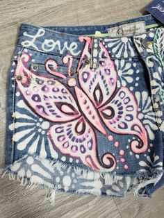 Remused upcycled denim shorts with colorful butterfly and image 2 Butterfly Bid Day, Painting On Jeans, Butterflies And Daisies, Jean Shorts Outfits, Decorate Clothes, Patched Denim, Patched Denim Jeans, Jean Short Outfits