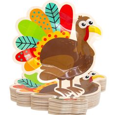 a turkey and her chicks on top of stacks of wooden plates