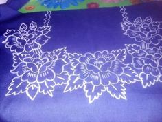 a blue and white cloth with flowers on it