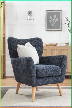 a blue chair sitting on top of a white rug