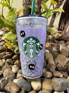 the starbucks cup is decorated with sprinkles and black cats on it's side