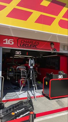 the garage is full of racing gear and equipment for drivers to work on their cars