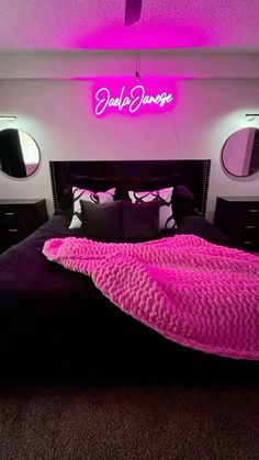 a bed that has a pink blanket on it