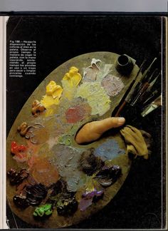 an artist's palette with paint and brushes