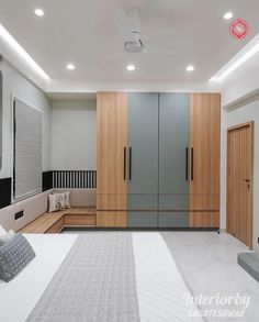 a bedroom with white walls and wooden furniture in the center, along with built - in closets