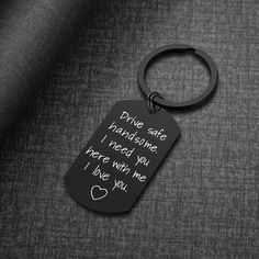 a black keychain with the words drive safe and someone i need you here with me