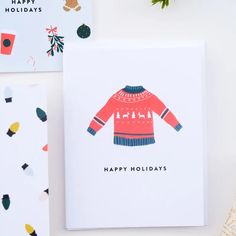 a christmas card with an ugly sweater on the front and happy holidays written on the back