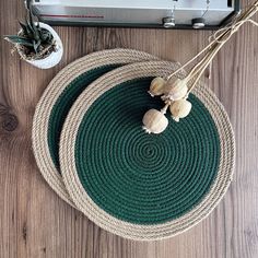 two round placemats with garlic on them next to an old radio and plant