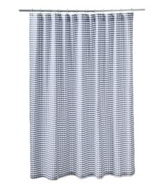 a blue and white checkered shower curtain with metal grommet hooks on the side