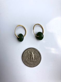 A stunning pair of modern-look dark green jade donut drop earrings.Simple and elegant. Hand-made from the premium 100% natural and real green nephrite green jades circle and 925 sterling silver plated with 18K gold in a minimalistic style. The stylish gold and green minimalistic design is great for your day-to-day classic wear or special occasions. Perfect as a gift for yourself or your loved ones. Some highlights of this pair of eye-catching genuine dark green jade drop earrings are: *High-qual Modern Green Round Hoop Earrings, Handmade Jade Hoop Earrings, Green Jade Hoop Jewelry, Green Round Huggie Earrings For Pierced Ears, Green Round Huggie Earrings, Small Green Pierced Hoop Earrings, Everyday Green Huggie Earrings, Green Emerald Small Hoop Earrings, Small Hoop Emerald Earrings In Green