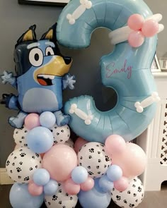 the balloon is shaped like an angry bird and has balloons attached to it that spell out the number three